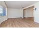 Spacious living room with wood-look flooring, natural light, and an open concept design at 3445 Briar Cliff Dr, Holiday, FL 34691