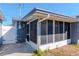 Exterior view of screened porch with access door at 3445 Briar Cliff Dr, Holiday, FL 34691