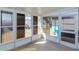 Bright sunroom features multiple sliding windows, tiled flooring and view of backyard at 3445 Briar Cliff Dr, Holiday, FL 34691