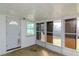 Enclosed sunroom has a door and wall of windows letting in lots of light at 3445 Briar Cliff Dr, Holiday, FL 34691