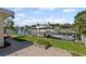 Waterfront backyard with dock, boat, green grass and a paved patio at 3497 Coquina Key Se Dr, St Petersburg, FL 33705
