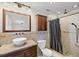 Bathroom boasts granite countertops, vessel sink, vanity, and shower at 3497 Coquina Key Se Dr, St Petersburg, FL 33705