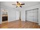 Bedroom boasts wood floors, ceiling fan, and attached bathroom with sink and shower at 3497 Coquina Key Se Dr, St Petersburg, FL 33705