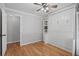 Bedroom with wood floors, ceiling fan, built-in shelves, and murphy bed at 3497 Coquina Key Se Dr, St Petersburg, FL 33705