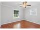 Bedroom features wood floors, ceiling fan, and windows that provide ample light at 3497 Coquina Key Se Dr, St Petersburg, FL 33705