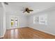 Bedroom features hardwood floors, ceiling fan, and french doors at 3497 Coquina Key Se Dr, St Petersburg, FL 33705