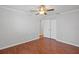 Comfortable bedroom with hardwood floors, white trim, ceiling fan, and closet at 3497 Coquina Key Se Dr, St Petersburg, FL 33705