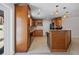 Traditional kitchen features tile floors, granite countertops, wooden cabinets and matching kitchen island at 3497 Coquina Key Se Dr, St Petersburg, FL 33705