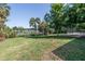 Expansive backyard with lush greenery and a view of the lake creates a tranquil oasis at 3629 Lake Breeze Dr, Land O Lakes, FL 34639