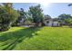 Lush green backyard provides ample space and a serene atmosphere, enhanced by mature trees at 3629 Lake Breeze Dr, Land O Lakes, FL 34639
