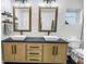 Modern bathroom offers dual sinks, wood cabinets, black hardware, and a sleek design at 3629 Lake Breeze Dr, Land O Lakes, FL 34639