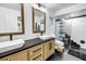Contemporary bathroom features dual sinks, black hardware, subway tile shower, and a modern design at 3629 Lake Breeze Dr, Land O Lakes, FL 34639