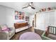 Playful Bedroom includes a changing table, crib, chair, and closet space at 3629 Lake Breeze Dr, Land O Lakes, FL 34639