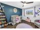 Charming Bedroom with a crib, bookshelf, and a cozy reading nook at 3629 Lake Breeze Dr, Land O Lakes, FL 34639