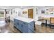 Eat-in kitchen and dining area with wood-look floors, island with marble countertop, and farmhouse style decor at 3629 Lake Breeze Dr, Land O Lakes, FL 34639