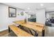Dining area open to the kitchen featuring a wooden table and modern light fixtures at 3629 Lake Breeze Dr, Land O Lakes, FL 34639
