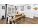 A well-lit dining room features a large wooden table, bench seating, and stylish lighting at 3629 Lake Breeze Dr, Land O Lakes, FL 34639