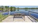 A tranquil lake view from the wooden dock, complete with a charming iron bench for relaxing at 3629 Lake Breeze Dr, Land O Lakes, FL 34639