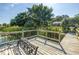 Wooden dock with a bench overlooking a serene lake surrounded by lush greenery at 3629 Lake Breeze Dr, Land O Lakes, FL 34639