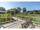 Wooden dock with a bench overlooking a serene lake with lush greenery at 3629 Lake Breeze Dr, Land O Lakes, FL 34639