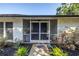 Inviting screened entryway with a stylish front door and lush landscaping at 3629 Lake Breeze Dr, Land O Lakes, FL 34639