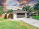 This home boasts a well-kept lawn, mature trees, an attached two-car garage, and a fenced yard at 3629 Lake Breeze Dr, Land O Lakes, FL 34639