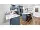 Beautiful kitchen featuring blue cabinets, stainless steel appliances, and a marble island with stool seating at 3629 Lake Breeze Dr, Land O Lakes, FL 34639