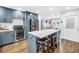Open kitchen with island, custom cabinets, stainless appliances and view to dining area at 3629 Lake Breeze Dr, Land O Lakes, FL 34639