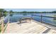 Picturesque bench on a wooden dock overlooking a tranquil lake with lily pads at 3629 Lake Breeze Dr, Land O Lakes, FL 34639