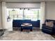 Living room showcasing an outdoor pool view, comfortable seating, and natural light at 3629 Lake Breeze Dr, Land O Lakes, FL 34639
