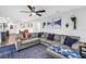 Comfortable living room featuring a large sectional sofa, a ceiling fan and stylish decor at 3629 Lake Breeze Dr, Land O Lakes, FL 34639