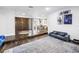 Open-concept living room featuring hardwood floors, modern décor, and a rustic dining table at 3629 Lake Breeze Dr, Land O Lakes, FL 34639