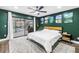 Spacious main bedroom features a ceiling fan, outdoor access to a pool area, and decorative artwork at 3629 Lake Breeze Dr, Land O Lakes, FL 34639