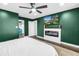 Main bedroom offers a fireplace, ceiling fan, television, and entry to closet at 3629 Lake Breeze Dr, Land O Lakes, FL 34639