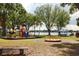 Community playground with slides and merry-go-round near the lake at 3629 Lake Breeze Dr, Land O Lakes, FL 34639