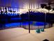 Relaxing screened-in pool area with string lights, ceiling fans, and comfortable outdoor seating at 3629 Lake Breeze Dr, Land O Lakes, FL 34639