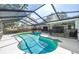 Large screened-in pool area with outdoor living space offers ultimate relaxation at 3629 Lake Breeze Dr, Land O Lakes, FL 34639