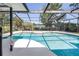 Screened-in pool with a beautiful water view offers relaxation and outdoor entertainment at 3629 Lake Breeze Dr, Land O Lakes, FL 34639