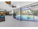 Large screened-in patio features a pool with a safety fence and lake view at 3629 Lake Breeze Dr, Land O Lakes, FL 34639
