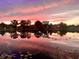 Beautiful sunset lake view reflecting colorful sky, highlighting the home's serene and scenic surroundings at 3629 Lake Breeze Dr, Land O Lakes, FL 34639