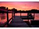 Wooden dock at sunset, providing a serene lakeside view for relaxation at 3629 Lake Breeze Dr, Land O Lakes, FL 34639