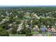 Expansive aerial shot showcasing a lush, established neighborhood dotted with mature trees and serene ponds at 3808 Hollow Wood Dr, Valrico, FL 33594
