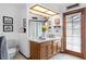 A well-lit bathroom with double sinks, vanity, decorative towels, and light fixtures at 3808 Hollow Wood Dr, Valrico, FL 33594
