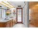 Bright bathroom featuring double sinks, wood cabinets, and a shower behind a decorative curtain at 3808 Hollow Wood Dr, Valrico, FL 33594
