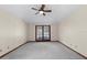 Carpeted bedroom with ceiling fan and sliding glass doors offering a view of the outdoors provides a cozy atmosphere at 3808 Hollow Wood Dr, Valrico, FL 33594