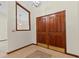 Inviting entryway features beautiful wood double doors, tile flooring, and a decorative mirror for a grand entrance at 3808 Hollow Wood Dr, Valrico, FL 33594