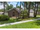 Charming brick home with lush landscaping and mature trees, offering great curb appeal at 3808 Hollow Wood Dr, Valrico, FL 33594