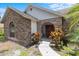 Charming brick home featuring an arched entryway and well-manicured landscaping at 3808 Hollow Wood Dr, Valrico, FL 33594