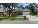 Charming single-story home with mature trees, a manicured lawn, and a two-car garage at 3808 Hollow Wood Dr, Valrico, FL 33594