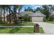 Charming single-story home with mature trees, a manicured lawn, and a two-car garage at 3808 Hollow Wood Dr, Valrico, FL 33594